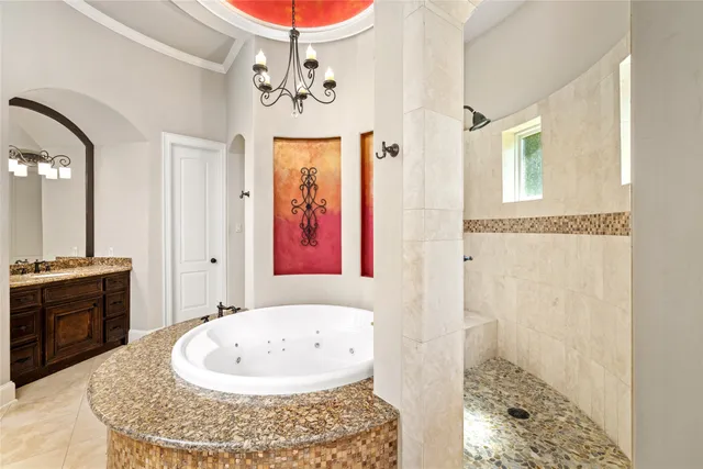 a bathroom with a tub sink and mirror