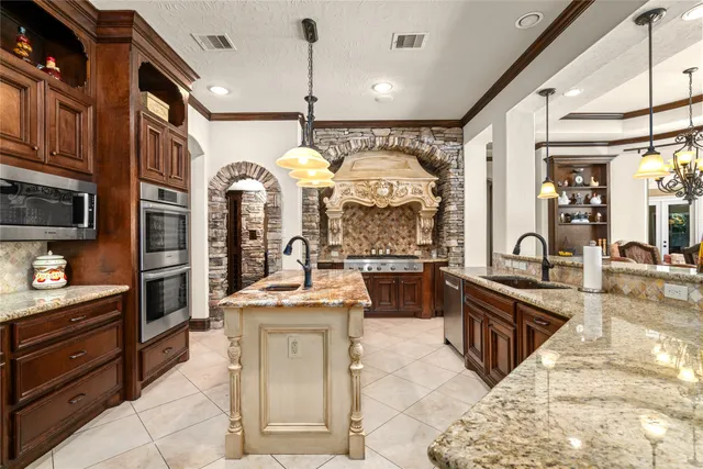 a large kitchen with stainless steel appliances kitchen island granite countertop a large counter top cabinets and stainless steel appliances