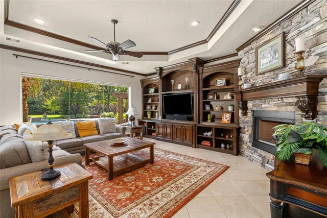 a living room with patio furniture and a flat screen tv
