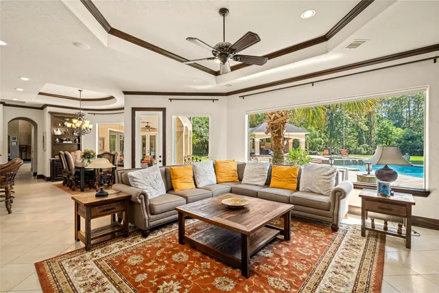 a living room with patio furniture and a large window