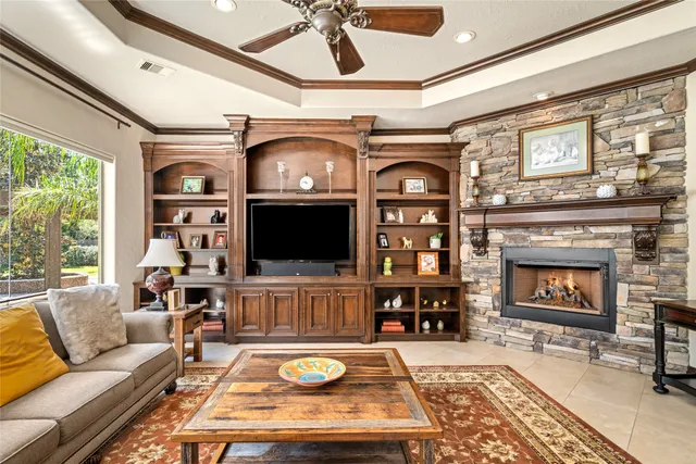 a living room with fireplace furniture and a flat screen tv