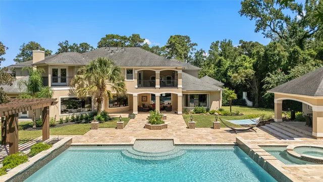 a front view of a house with garden and chairs