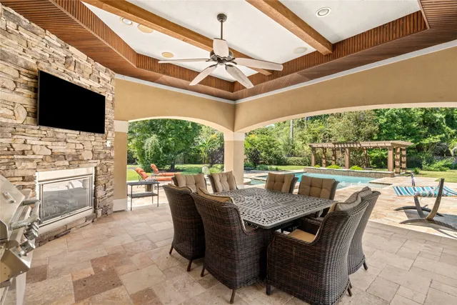 a view of a patio with a table chairs and a backyard
