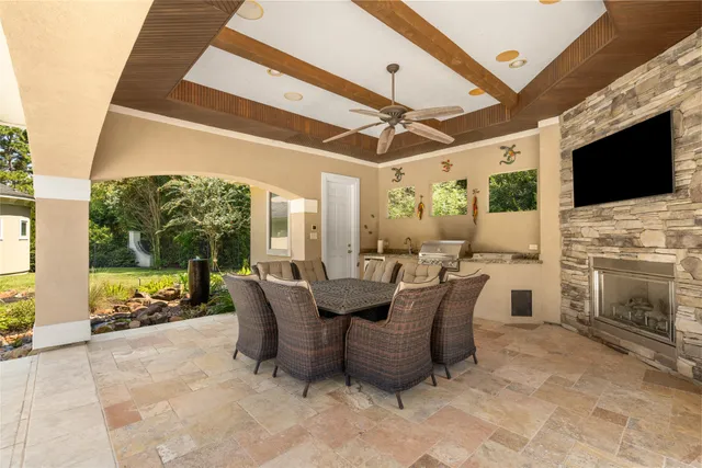 a dining room with furniture and a flat screen tv