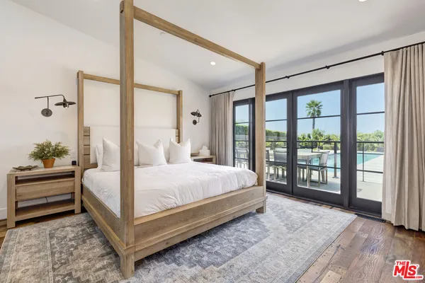 a bedroom with a large bed and a large window