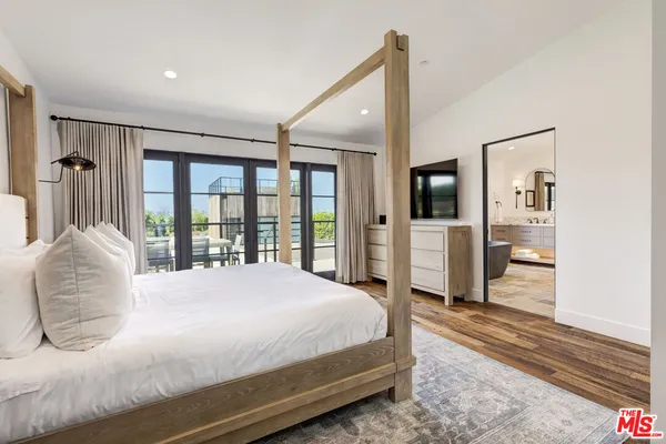 a bedroom with a large bed and a large window