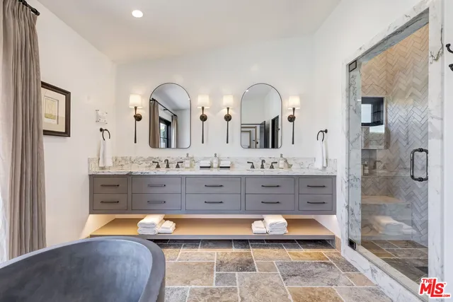 a bathroom with a tub sink and mirror