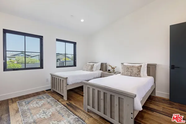 a bedroom with two beds and a window
