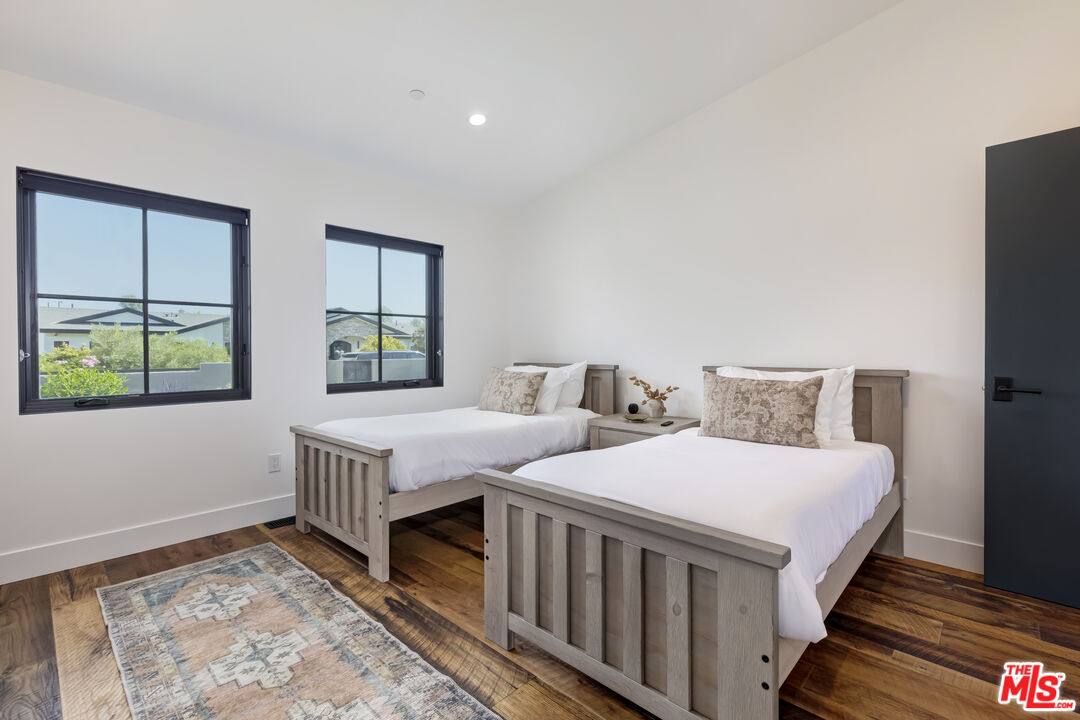 6711 Wandermere Road Malibu, CA 90265 - Photo 19 of 27 a bedroom with two beds and a window