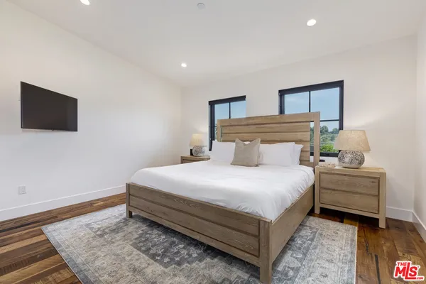 a bedroom with a bed and a flat screen tv