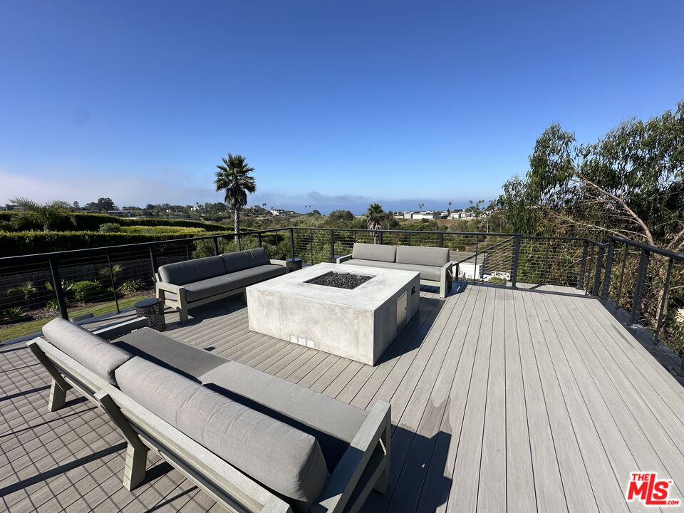 6711 Wandermere Road Malibu, CA 90265 - Photo 25 of 27 a roof deck with couches and wooden floor