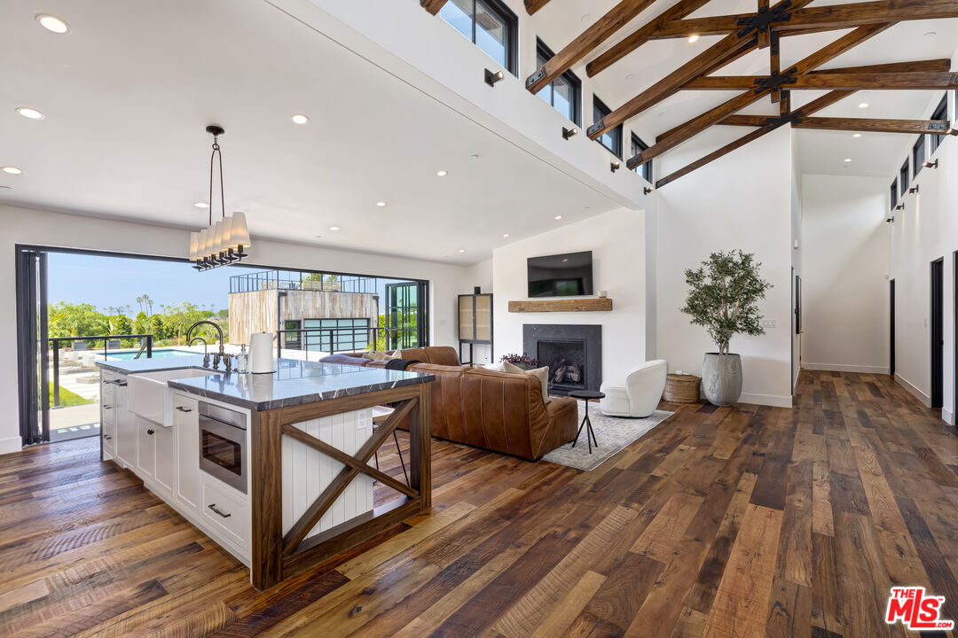 6711 Wandermere Road Malibu, CA 90265 - Photo 4 of 27 a open kitchen with stainless steel appliances granite countertop a stove and cabinets