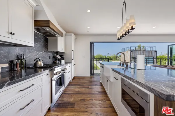 a large kitchen with granite countertop lots of counter space and window