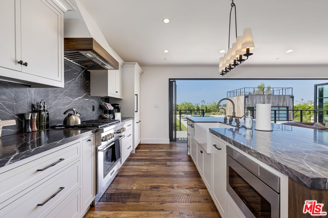 6711 Wandermere Road Malibu, CA 90265 - Photo 10 of 27 a large kitchen with granite countertop lots of counter space and window