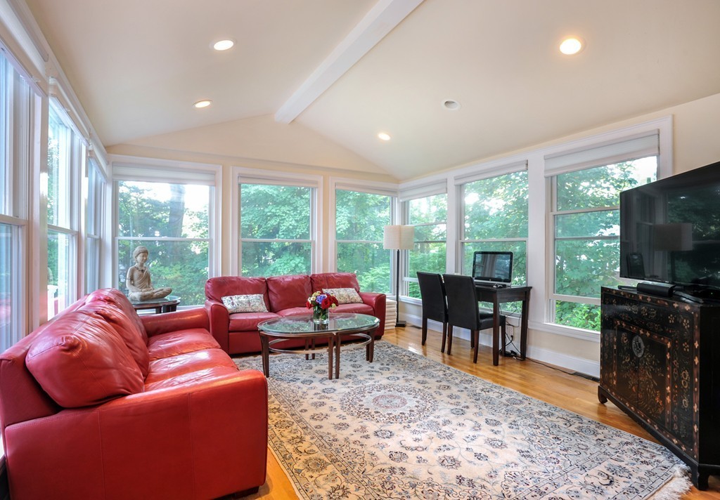 33 Wolcott Rd Extension Brookline, MA 02467 - Photo 7 of 28 a living room with furniture a flat screen tv and a floor to ceiling window