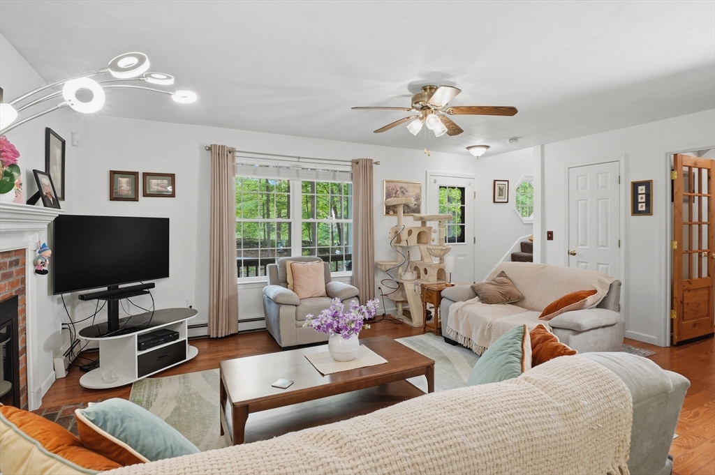 186 Common Street Groton, MA 01450 - Photo 8 of 28 a living room with furniture and a flat screen tv