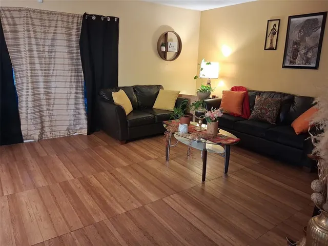 a bedroom with a bed and a flat tv screen on the dresser