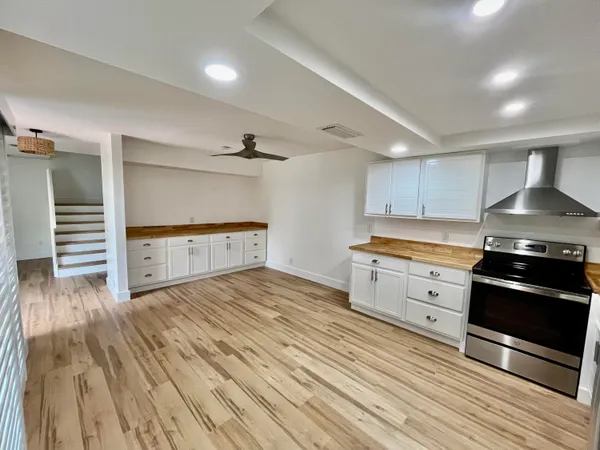 a kitchen with granite countertop a stove and a refrigerator