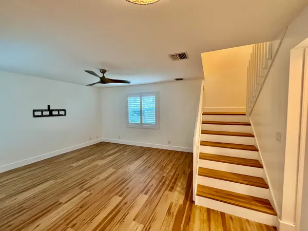 a view of a room with wooden floor and white walls