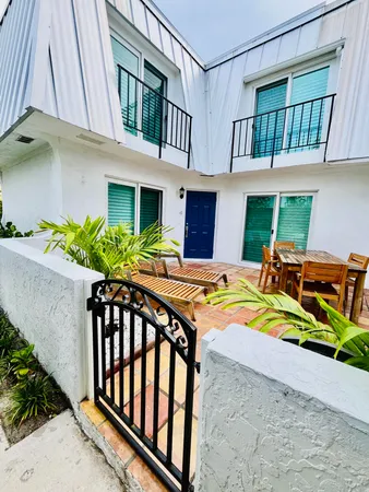 a view of a house with backyard and sitting area