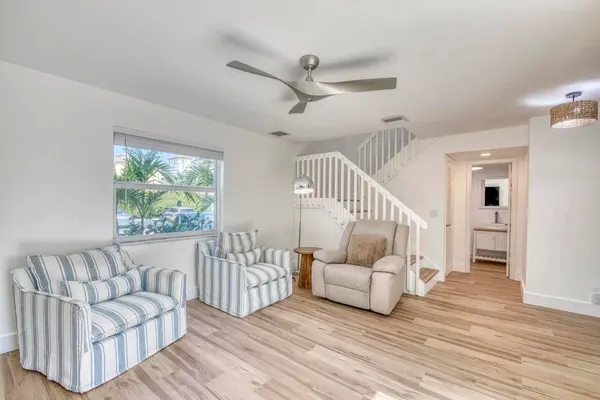 a living room with furniture and wooden floor