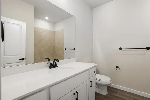 a bathroom with a shower sink and mirror