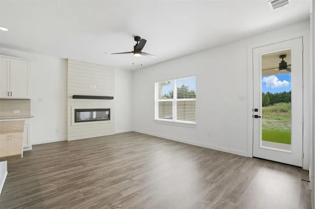 a living room with furniture kitchen area and a view of kitchen