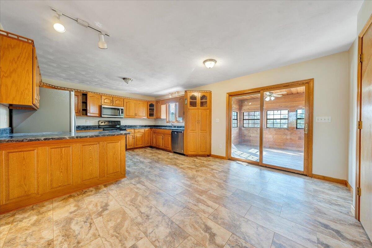 1296 3 Oaks Road Wirtz, VA 24184 - Photo 14 of 59 a large kitchen with stainless steel appliances granite countertop a refrigerator and a stove top oven