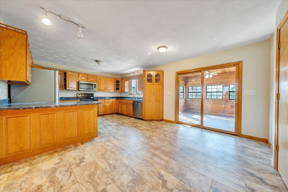 1296 3 Oaks Road Wirtz, VA 24184 - Photo 15 of 59 a large kitchen with stainless steel appliances granite countertop a refrigerator and a stove top oven