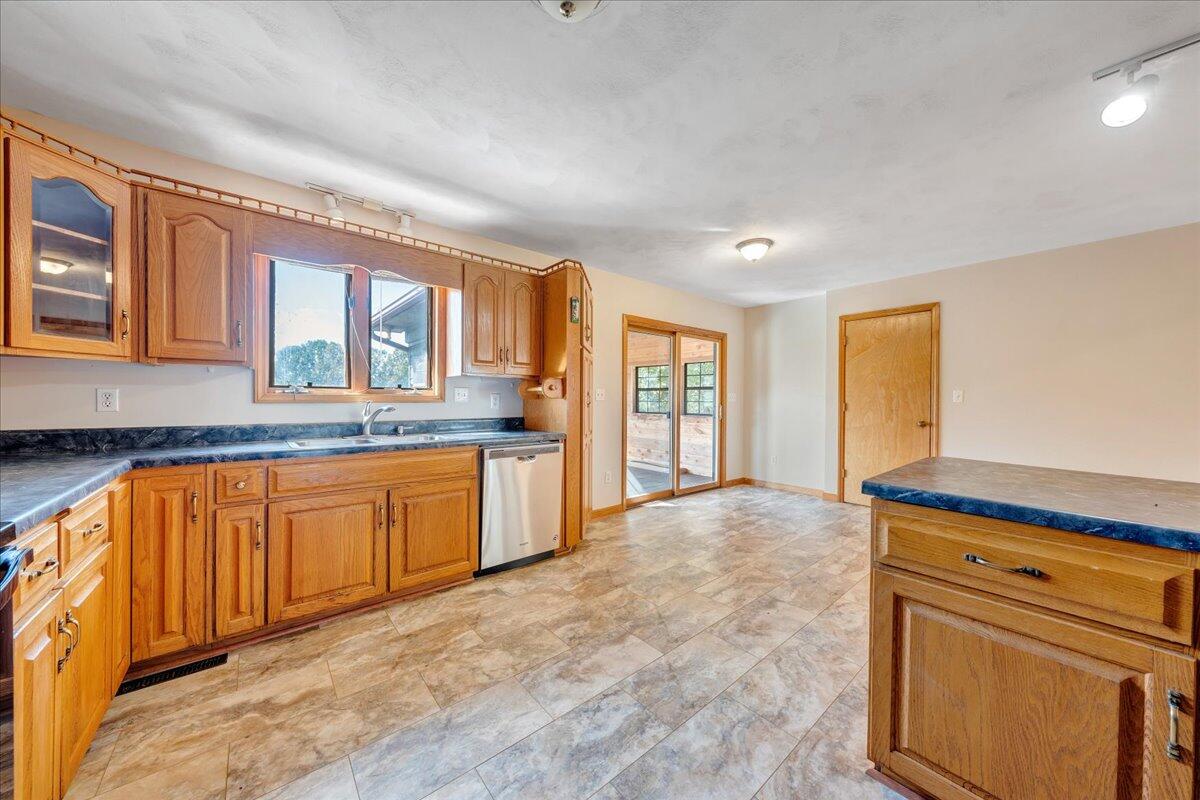1296 3 Oaks Road Wirtz, VA 24184 - Photo 18 of 59 a large kitchen with stainless steel appliances granite countertop a stove a sink and a refrigerator