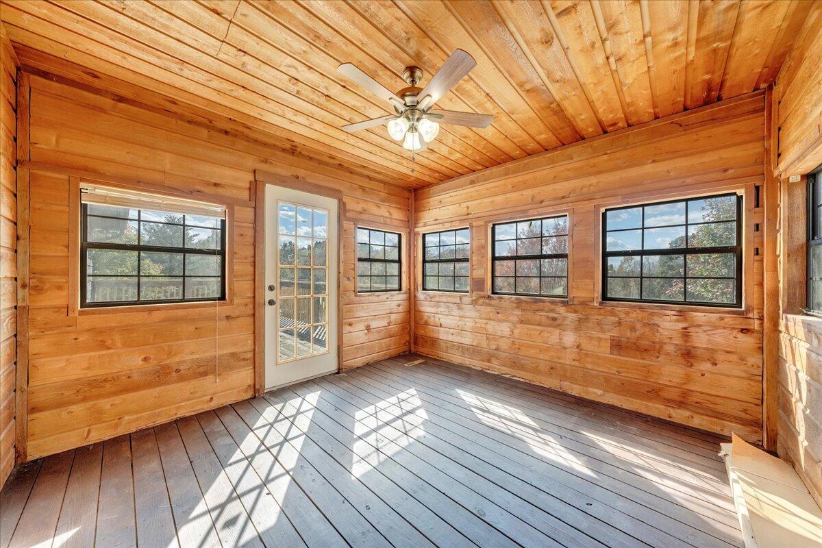 1296 3 Oaks Road Wirtz, VA 24184 - Photo 19 of 59 a view of an empty room with wooden floor and a window