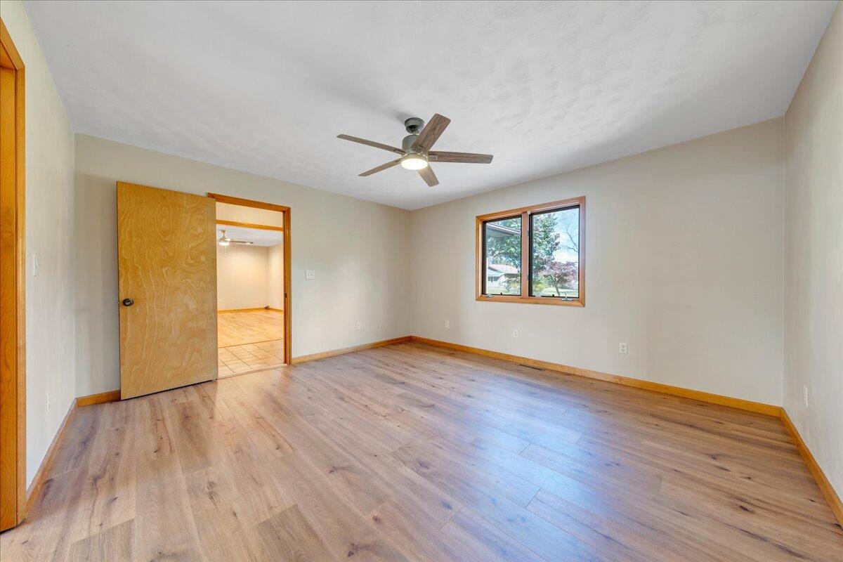 1296 3 Oaks Road Wirtz, VA 24184 - Photo 22 of 59 an empty room with wooden floor chandelier and windows