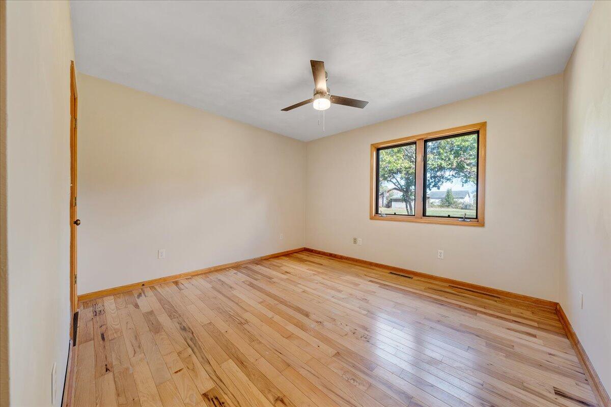 1296 3 Oaks Road Wirtz, VA 24184 - Photo 27 of 59 a view of an empty room with wooden floor and a window