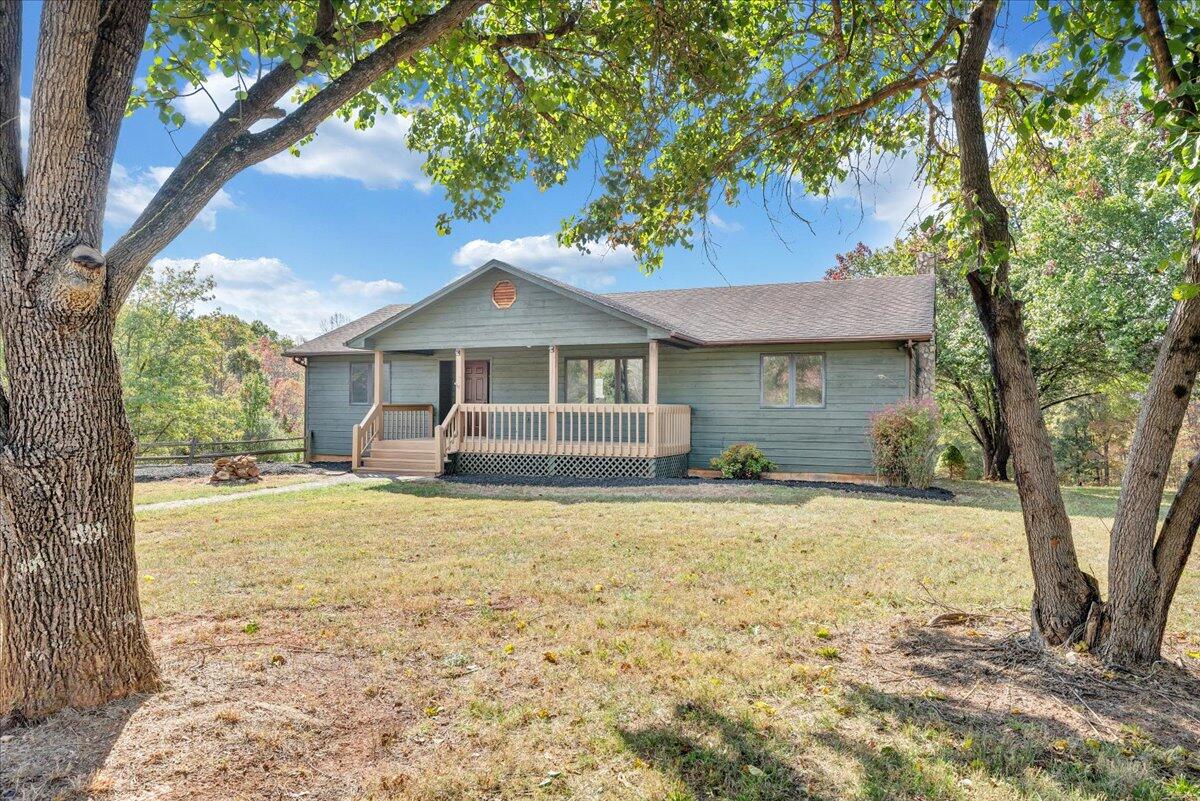1296 3 Oaks Road Wirtz, VA 24184 - Photo 3 of 59 a front view of a house with a garden and trees