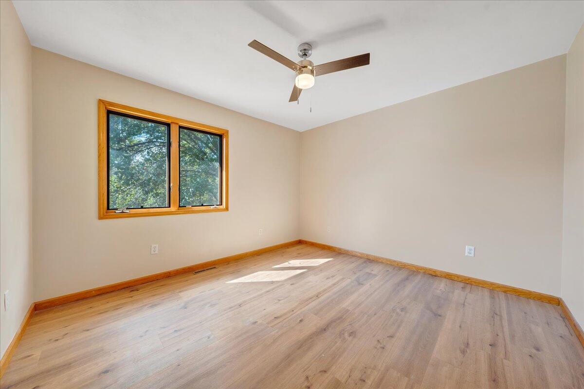 1296 3 Oaks Road Wirtz, VA 24184 - Photo 31 of 59 a view of an empty room with wooden floor and a window