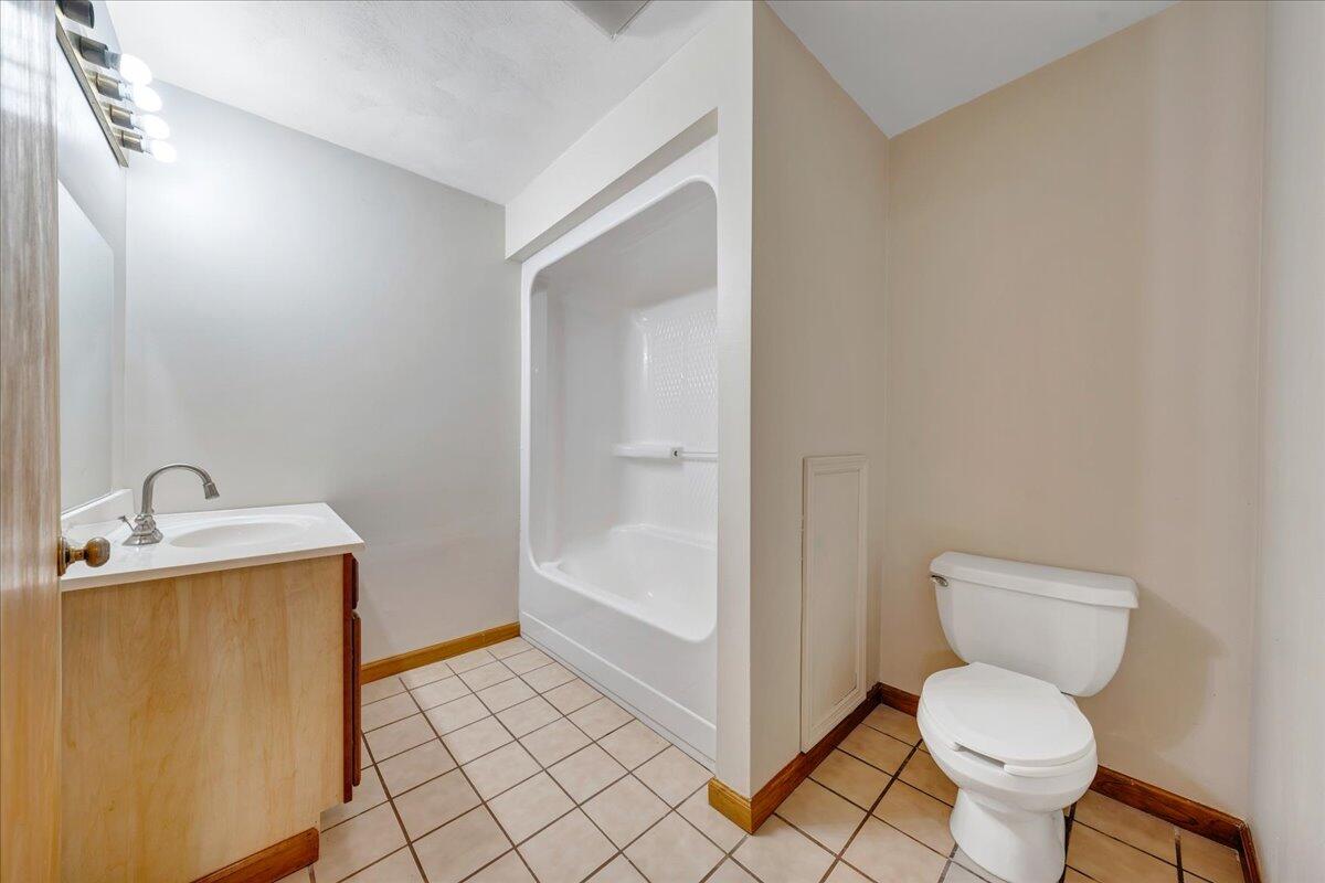 1296 3 Oaks Road Wirtz, VA 24184 - Photo 36 of 59 a bathroom with a granite countertop toilet and sink