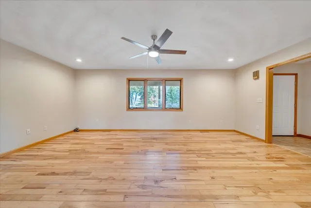 a view of an empty room and wooden floor