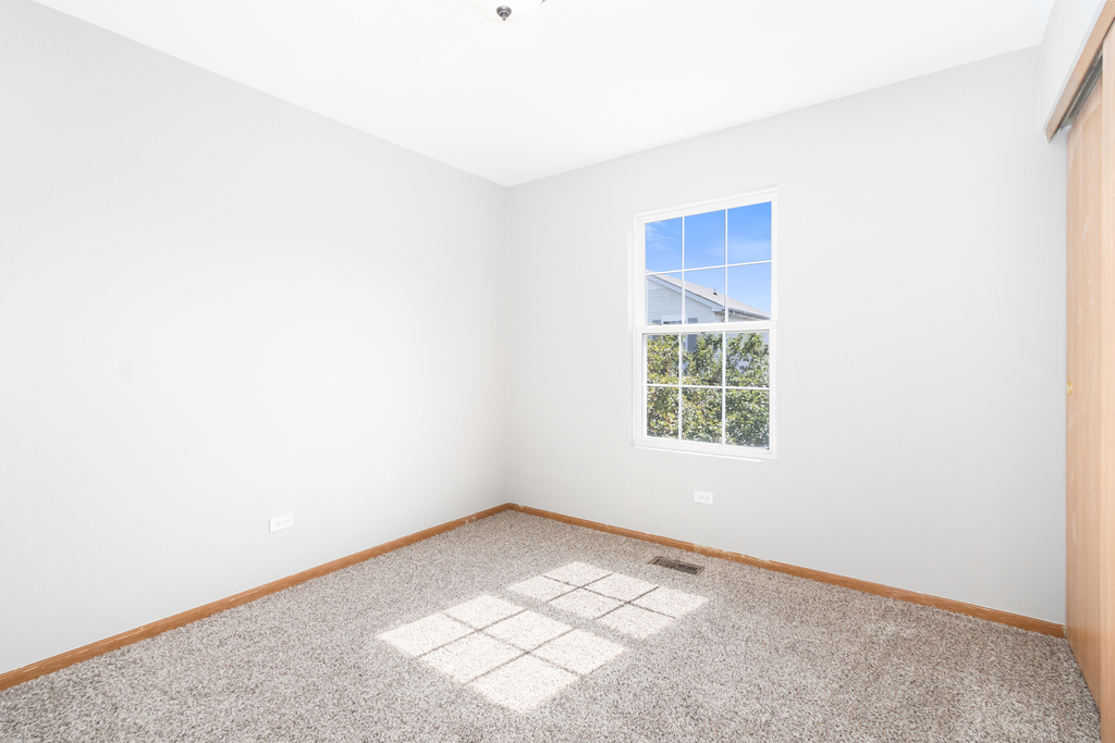 191 Mountain Laurel Court Romeoville, IL 60446 - Photo 12 of 25 an empty room with a window