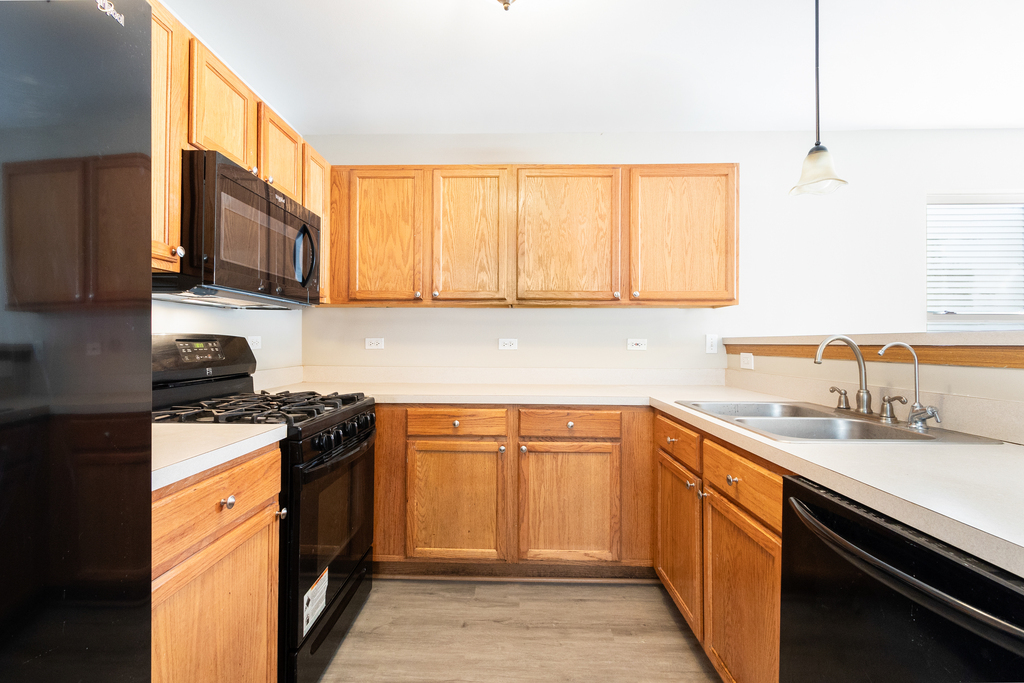191 Mountain Laurel Court Romeoville, IL 60446 - Photo 8 of 25 a kitchen with stainless steel appliances granite countertop a sink stove and refrigerator
