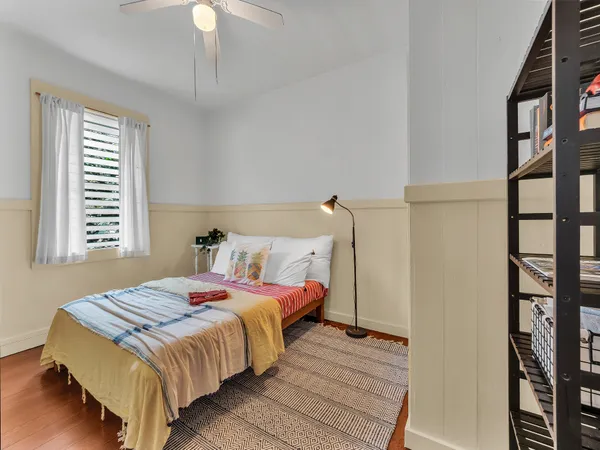 a bedroom with a bed and a window