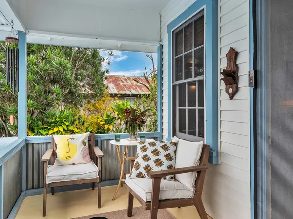 a balcony with table and chairs
