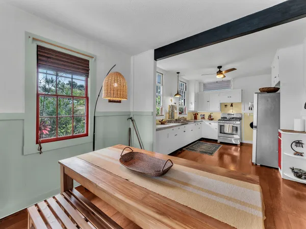 a bedroom with a bed and a view of kitchen