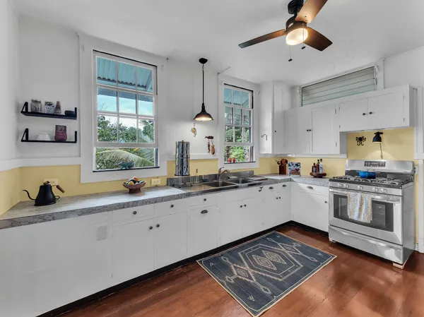a kitchen with a sink stove and cabinets
