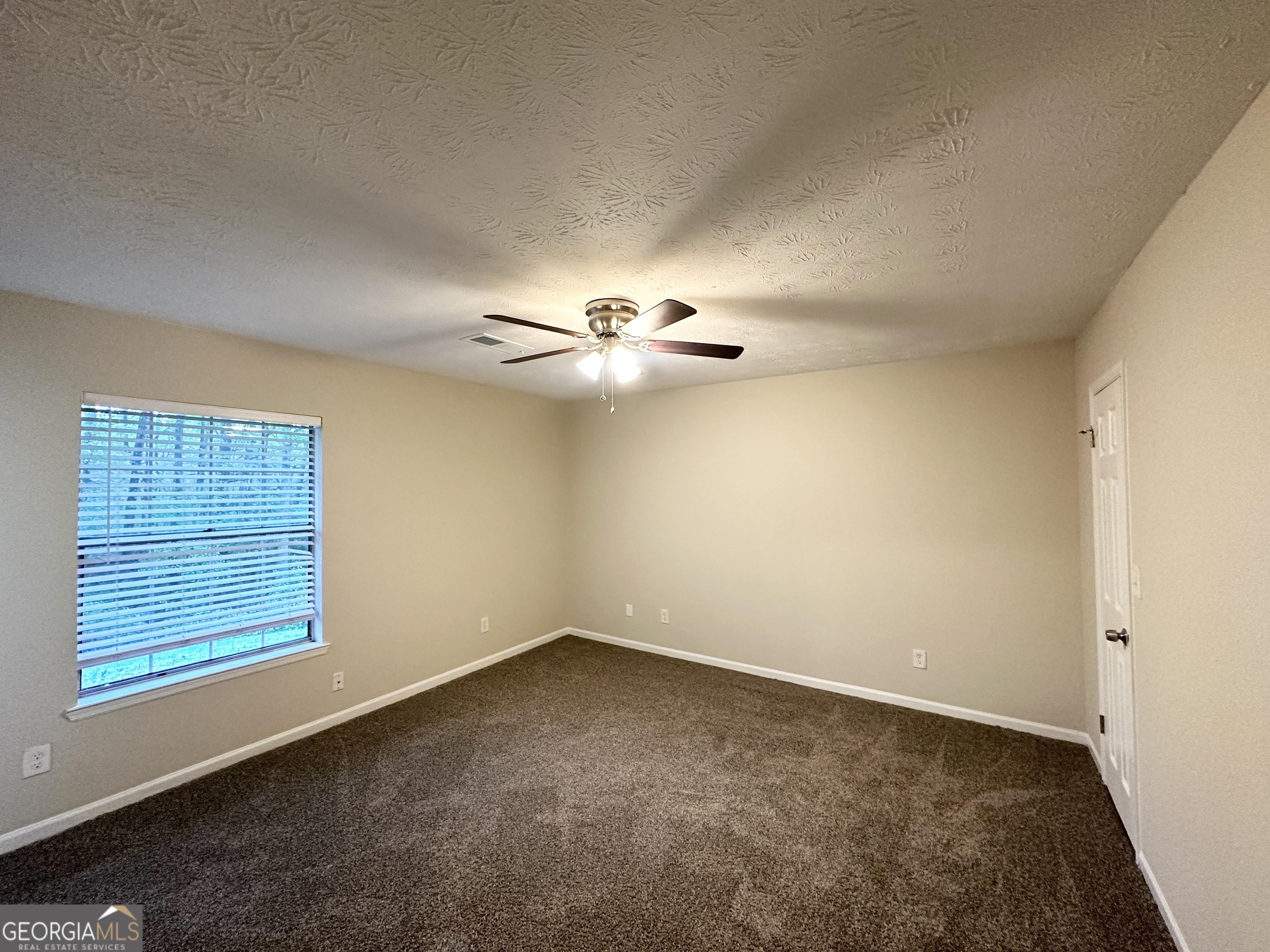 3865 Lehigh Boulevard Decatur, GA 30034 - Photo 15 of 19 an empty room with windows and fan