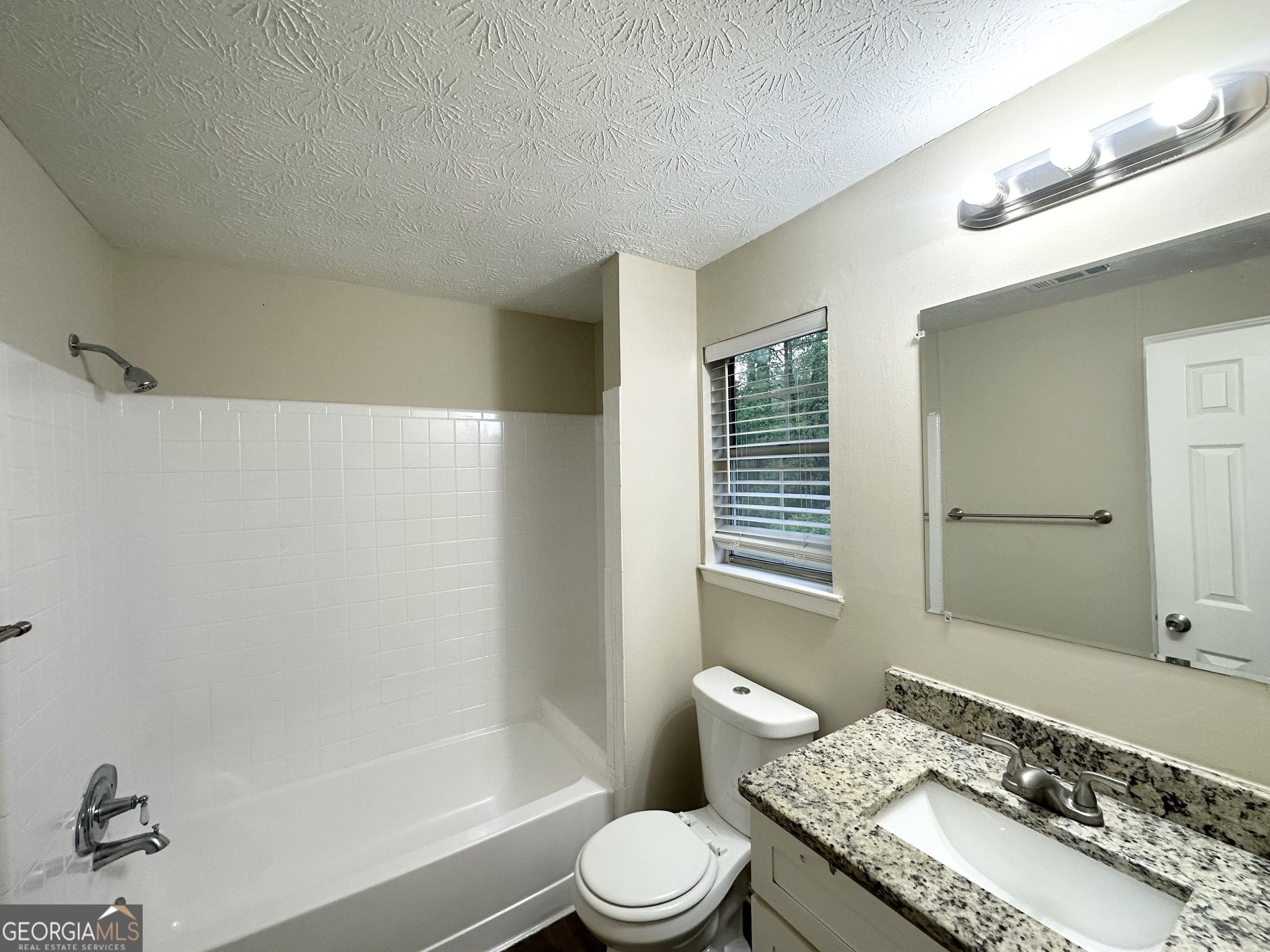 3865 Lehigh Boulevard Decatur, GA 30034 - Photo 17 of 19 a bathroom with a granite countertop sink toilet and shower