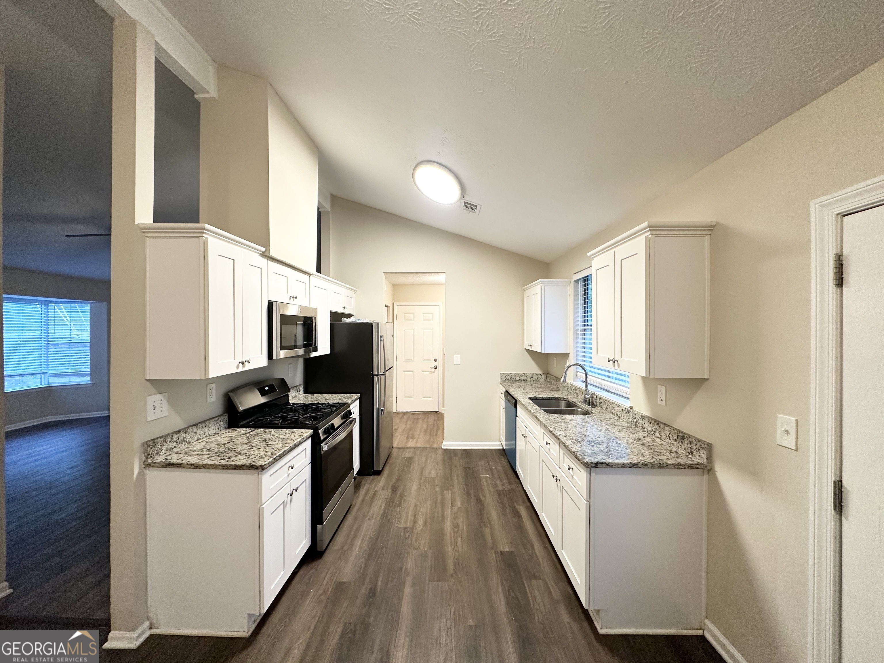 3865 Lehigh Boulevard Decatur, GA 30034 - Photo 6 of 19 a kitchen with a stove top oven a sink a counter space and cabinets