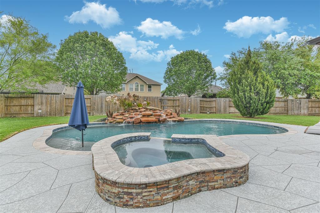 Enjoy being outside under your covered patio, with a built in outdoor kitchen, heated pool and spa. Decking was recently updated.