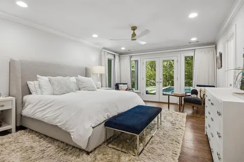 a spacious bedroom with a bed a table and a couch