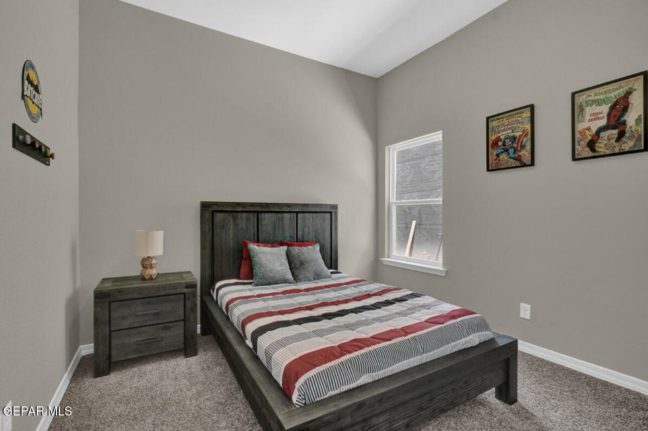 12434 Fill Ball Street El Paso, TX 79928 - Photo 26 of 32 a bedroom with a bed and a window