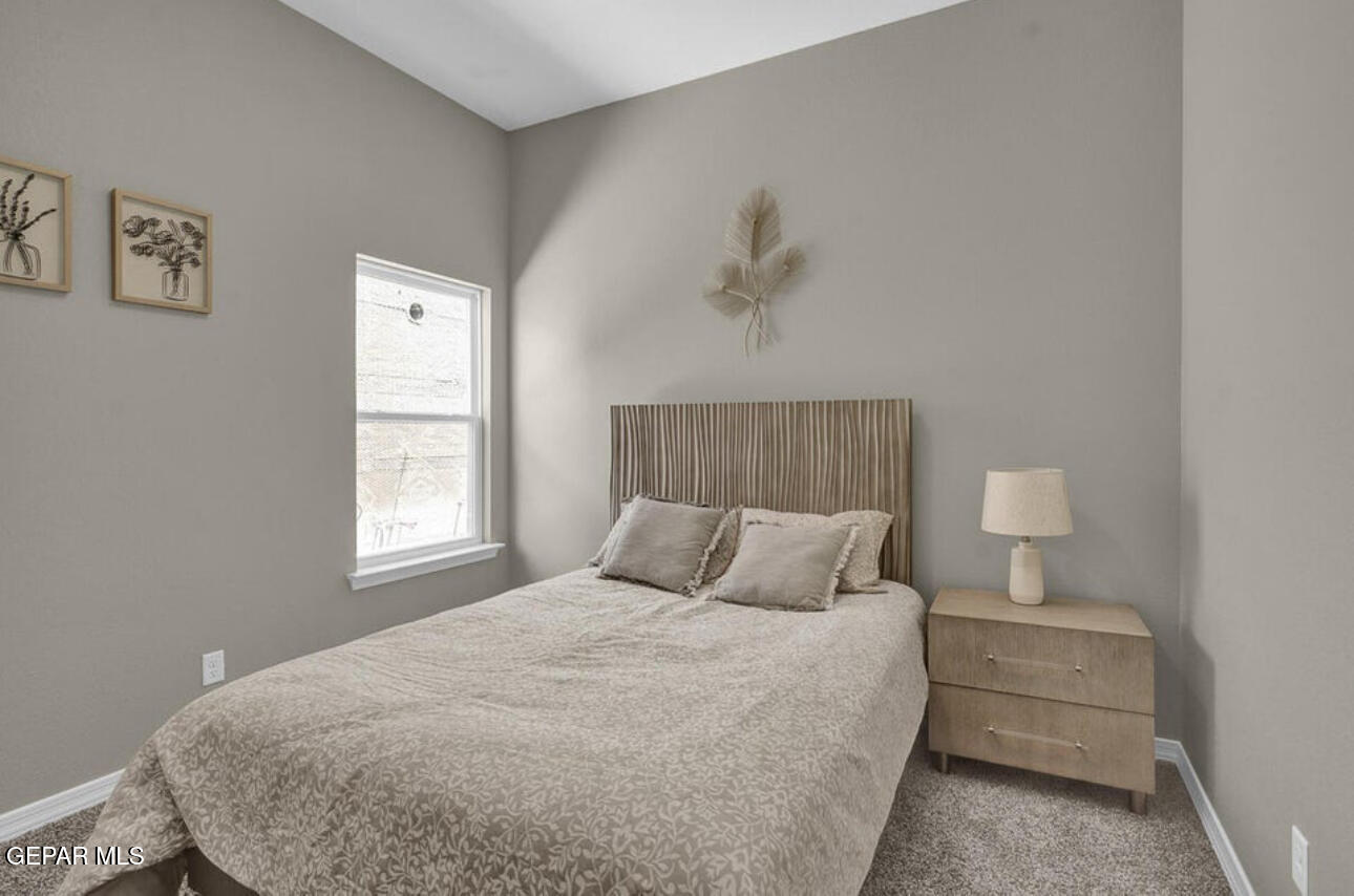 12434 Fill Ball Street El Paso, TX 79928 - Photo 30 of 32 a bedroom with a bed and a window